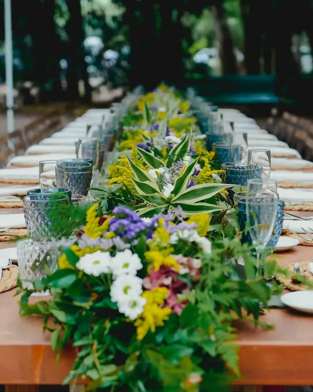 Long wedding table set with a flower runner at an estate in Tenerife